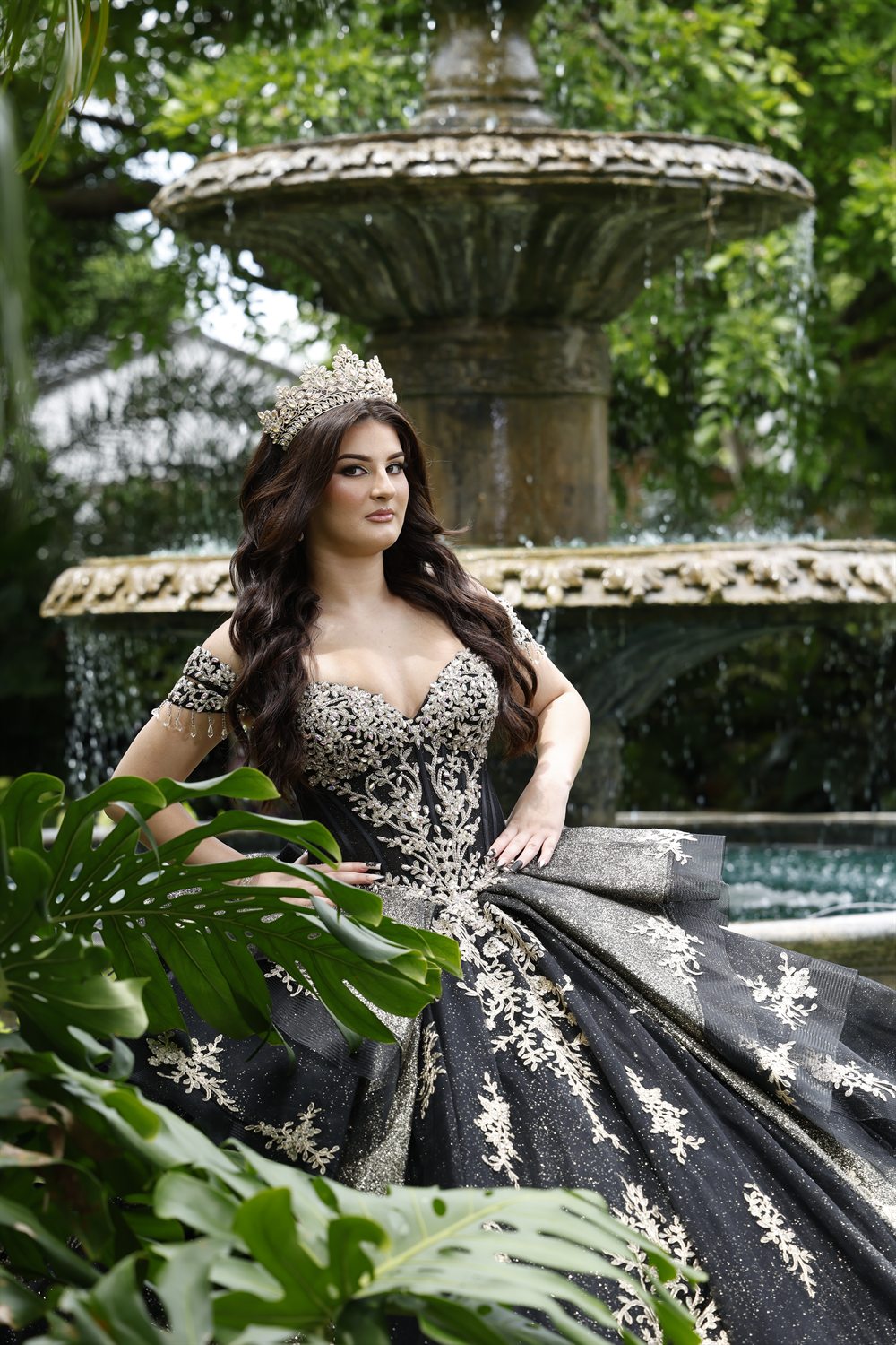 Isabella standing by the garden fountain