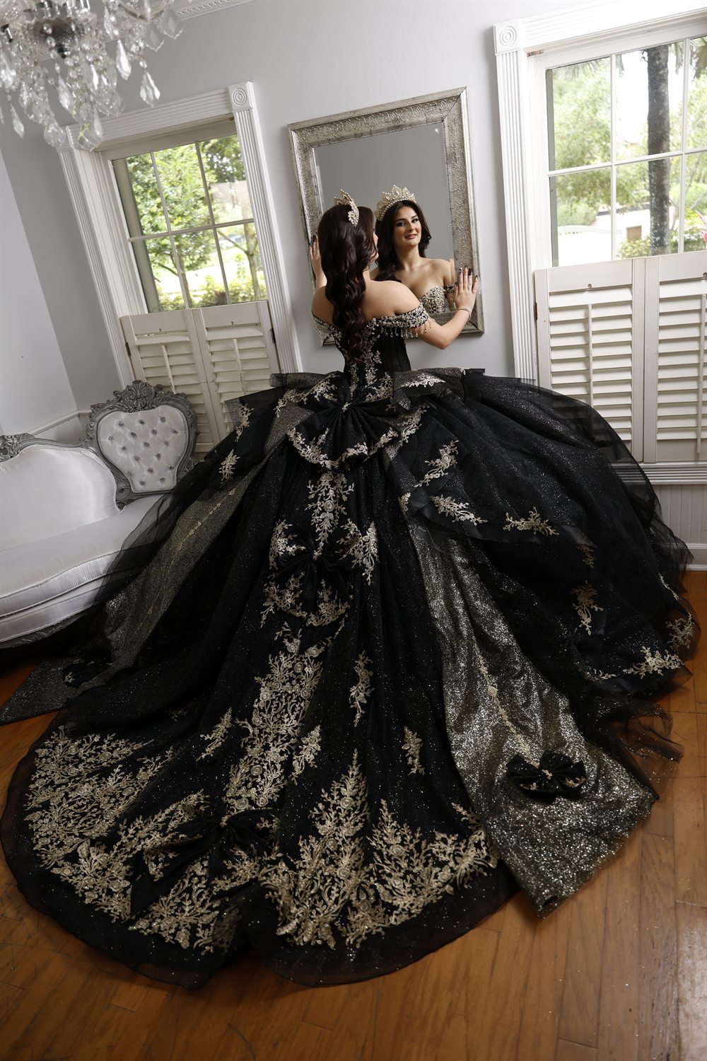 Isabella's gown spread before the gilded mirror