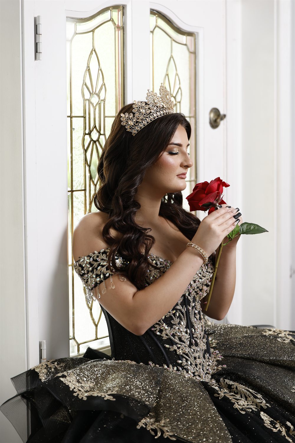 Isabella holding a single red rose